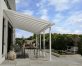 White Olympia patio cover, 3m x 8.6m, with an aluminum frame and clear polycarbonate panels for outdoor shade and weather protection