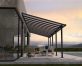 Grey Olympia patio cover, 3m x 9.2m, with an aluminum frame and clear panels, providing outdoor shade and weather protection