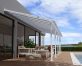 White Olympia patio cover, 3m x 9.8m, with a robust aluminum frame and clear polycarbonate panels for optimal weather protection