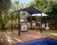 Black Austin 1.8m x 2.4m garden gazebo with a polycarbonate roof and aluminium frame, providing stylish outdoor shelter
