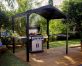 Outdoor grill station under an Austin 1.8m x 2.4m black aluminium garden gazebo with a polycarbonate roof