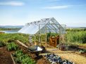 10ft x 20ft silver Balance greenhouse with aluminum frame and clear polycarbonate panels, set in a garden environment with plants inside