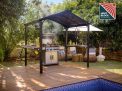 Outdoor grill station under an Austin 1.8m x 2.4m black aluminium garden gazebo with a polycarbonate roof featuring HeatBlock technology