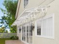White Bordeaux 8.9m x 1.4m Door Canopy with mist polycarbonate panels, offering stylish and reliable protection over entrances