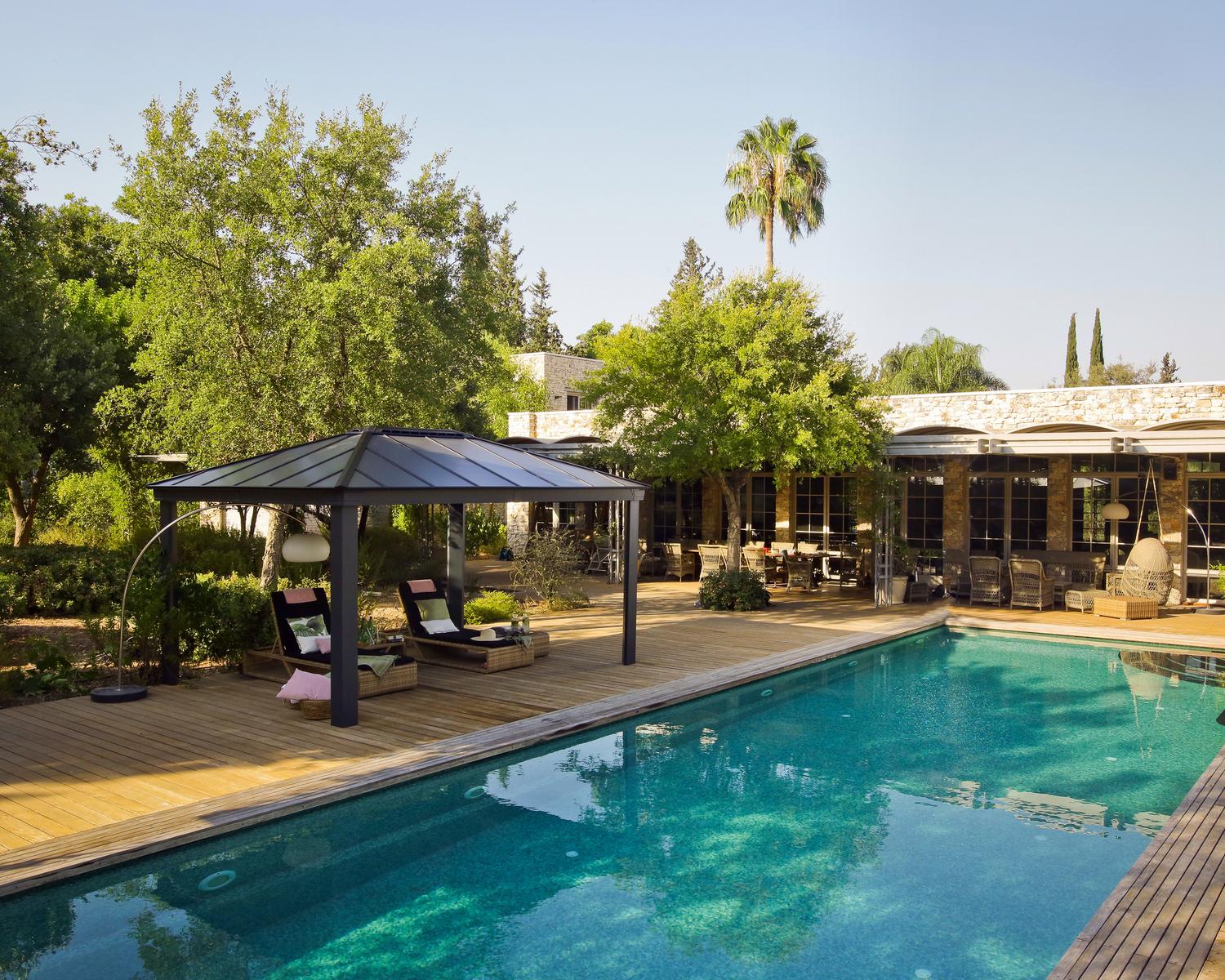 Spacious Dallas 3.6m x 5m grey garden gazebo with a sturdy aluminum frame and twin-wall polycarbonate roof panels featuring HeatBlock technology.