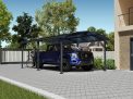 12ft x 21ft Arcadia carport with a grey aluminum frame and polycarbonate roof, offering shelter for a pickup truck next to a brick house