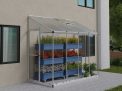 8ft x 4ft silver Lean-To Grow House with clear polycarbonate panels, aluminum frame, and plants inside during a snowfall