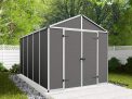 8ft x 12ft grey Rubicon garden shed with a strong aluminum frame and polycarbonate panels, nestled among greenery and a white fence
