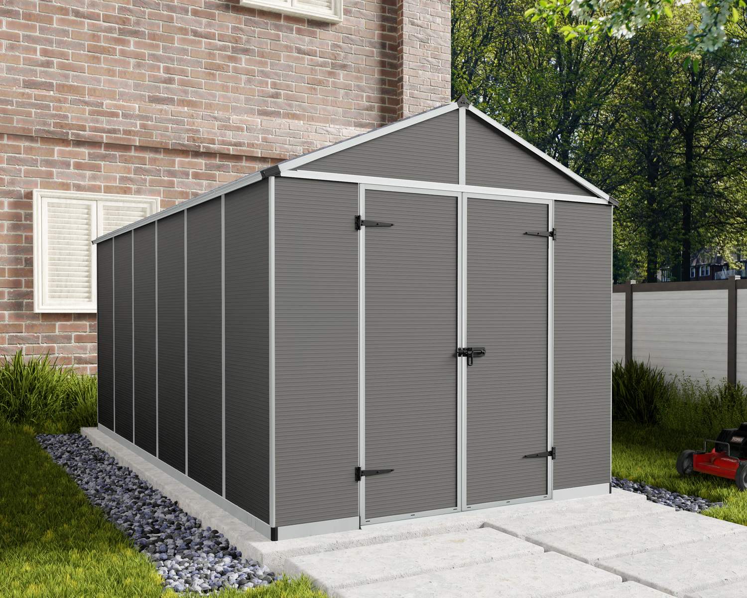 8ft x 15ft grey Rubicon garden shed with a durable aluminum frame and polycarbonate panels, situated next to a brick house and lush green lawn