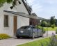 A blue Tesla is covered by a Faria 13 ft. x 26 ft. lean-to carport